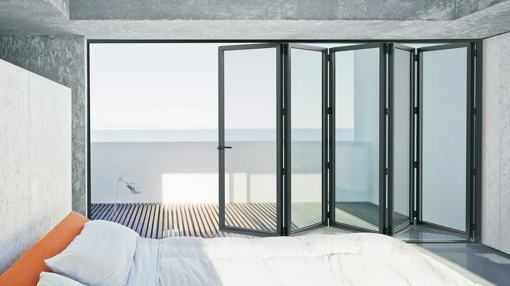 Dormitorio con una puerta plegable de aluminio abierta a la terraza
